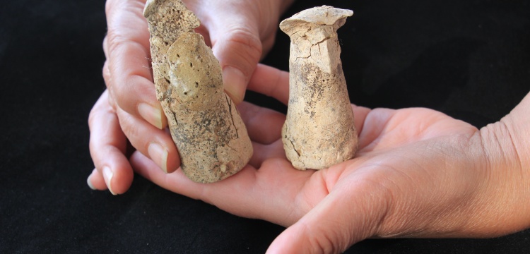 Archaeologists found two 7700-year-old ceramic figures, one male and one female, wearing hats in Izmir.